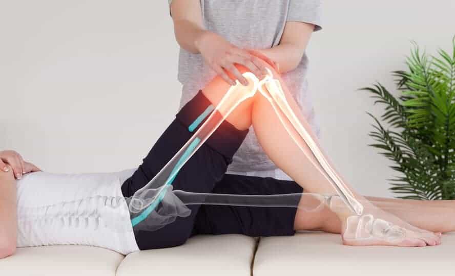 chiropractic patient's leg and x-ray hybrid highlighting knee pain