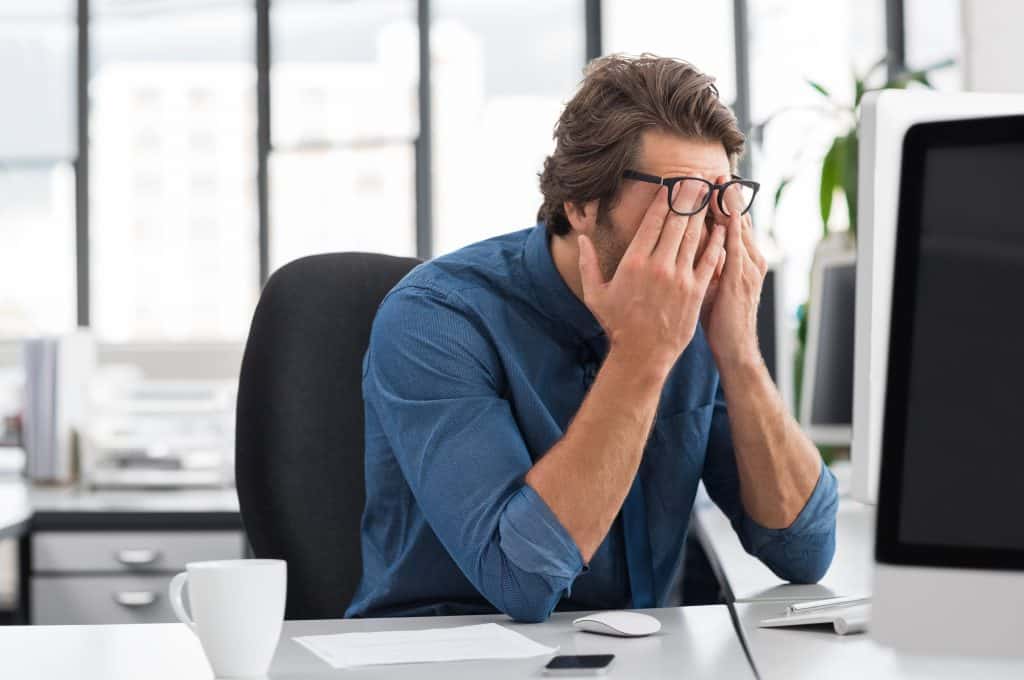 man stressed at a computer