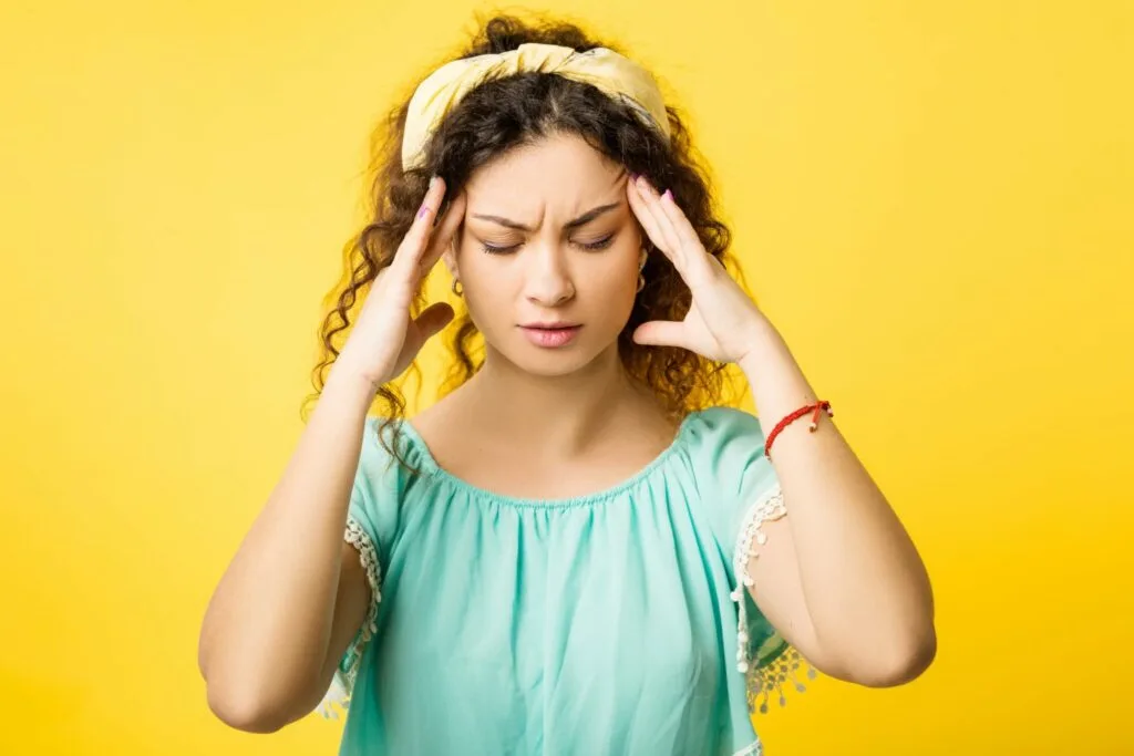 What's the Difference Between a Migraine and a Headache? 11 a woman suffering from PMS headache in Columbus Ohio