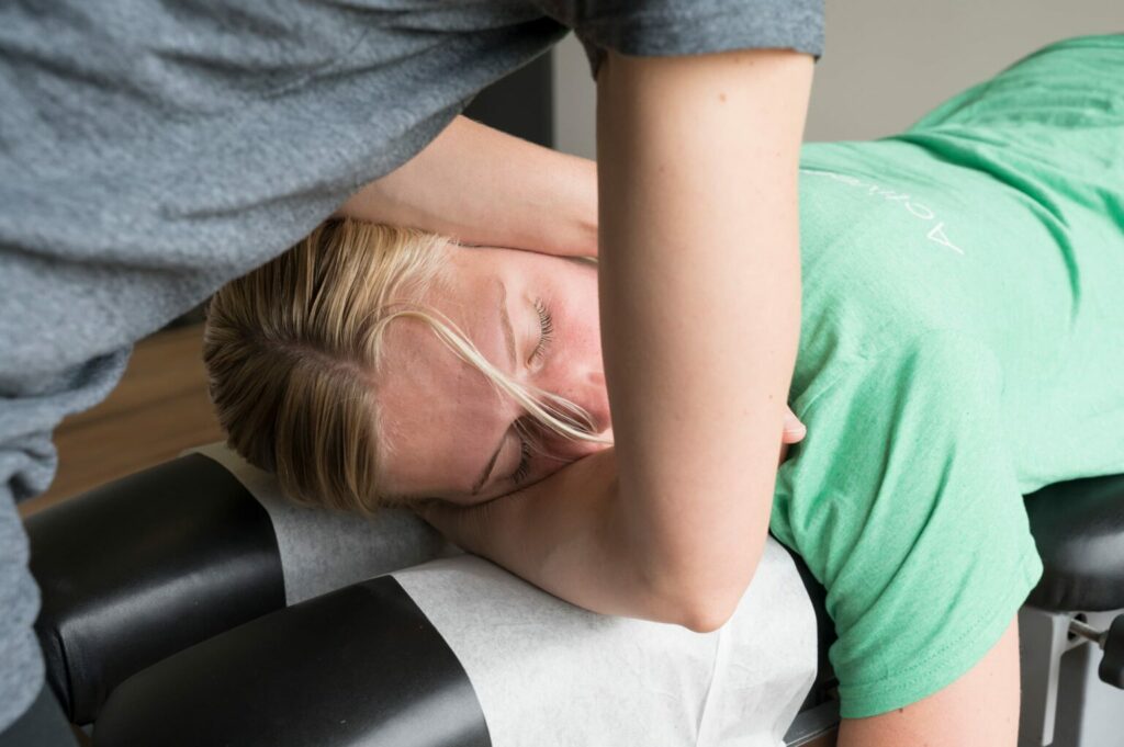 a female patient receiving chiropractic care in her neck from an Active Edge Chiropractor