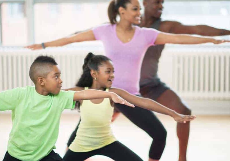 family stretching and doing yoga together