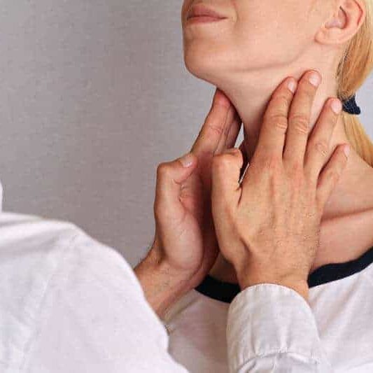 patients neck being examined by doctor