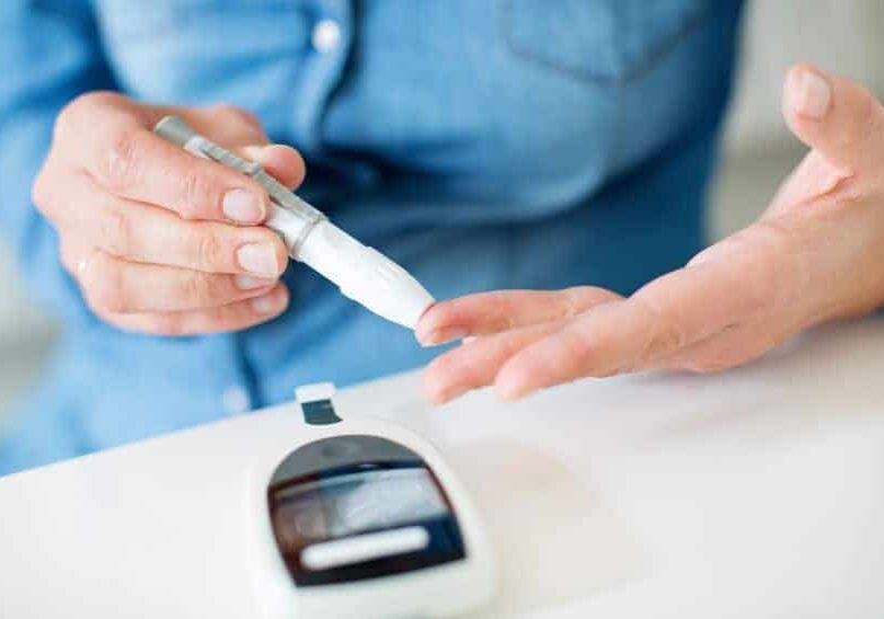 woman pricking her finger for diabetes testing